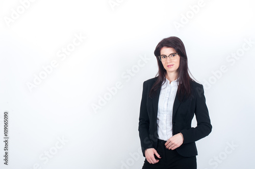 Slim woman with glasses and a strict suit