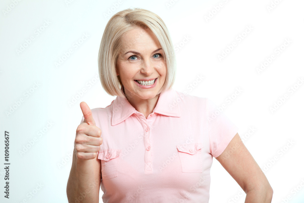 Happy attractive middle aged woman showing thumbs up, okay. Isolated Happy attractive middle aged woman showing thumbs up, okay. Isolated