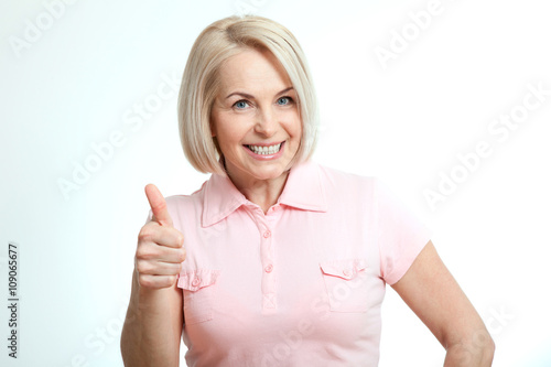 Wallpaper Mural Happy attractive middle aged woman showing thumbs up, okay. Isolated Torontodigital.ca