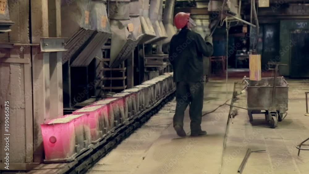 Worker in foundry controlling iron smelting in furnaces. HD. Worker in foundry controlling iron smelting in furnaces. HD.