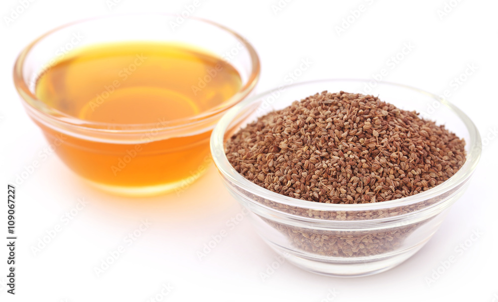 Ajwain seeds in a glass bowl with essential oil Ajwain seeds in a glass bowl with essential oil