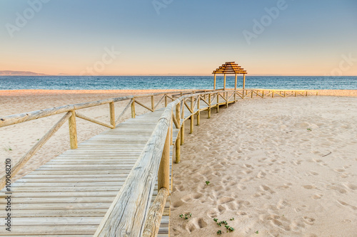 Wooden boardwalk to the beach. Idyllic scene photo