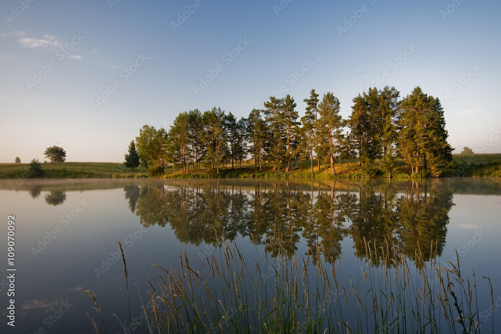 Sunset landscape over the tranquil lake
