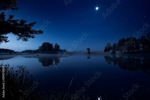 Moon rising over lake