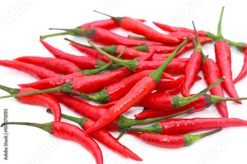 Chilli pepper in green bowl isolated on a white background