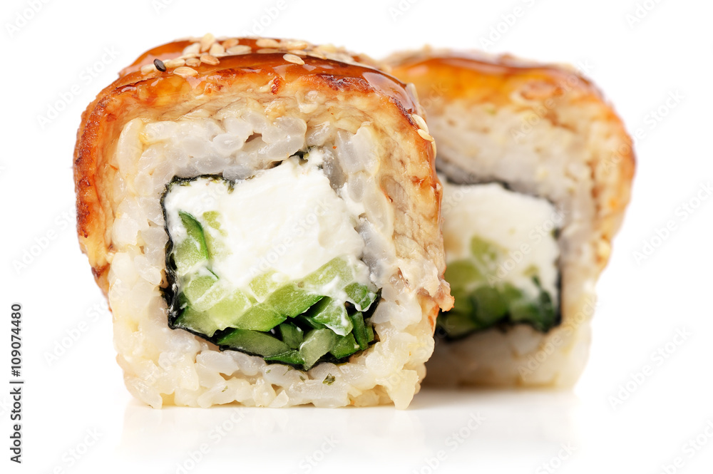 Sushi rolls with cream cheese, nori and cucumber covered with eel Sushi rolls with cream cheese, nori and cucumber covered with eel