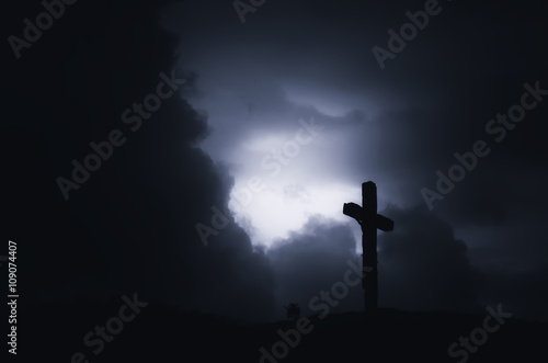 Cross silhouette on dramati...