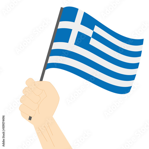 Hand holding and raising the national flag of Greece