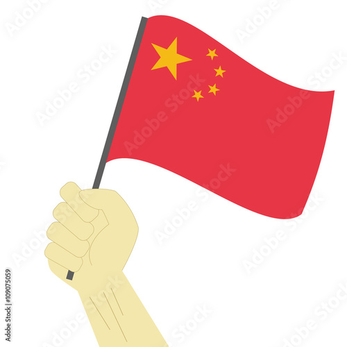 Hand holding and raising the national flag of China