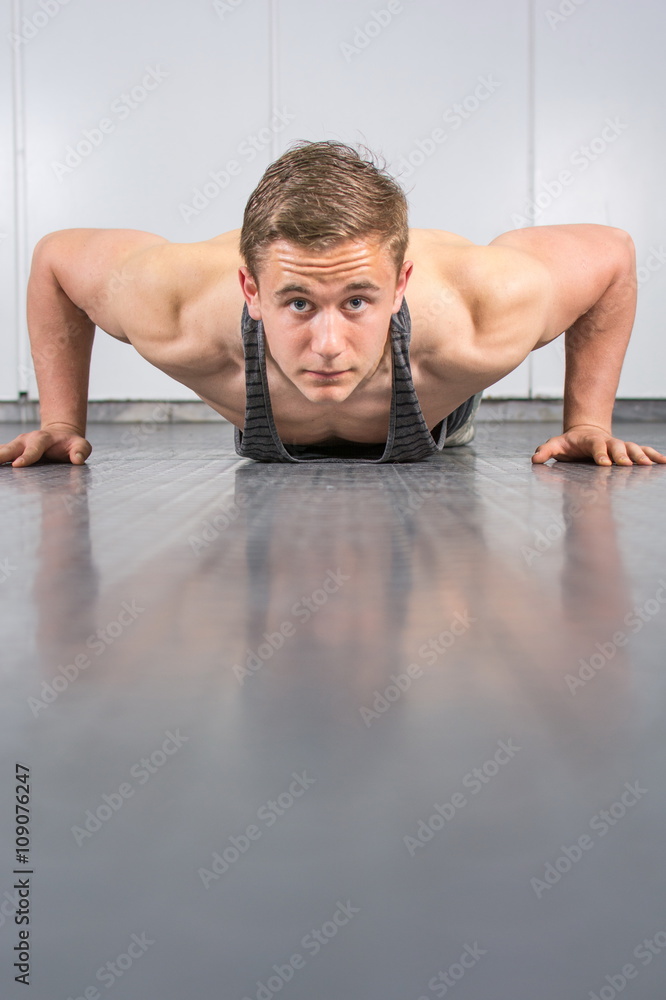 Man performing push ups at the gym Man performing push ups at the gym
