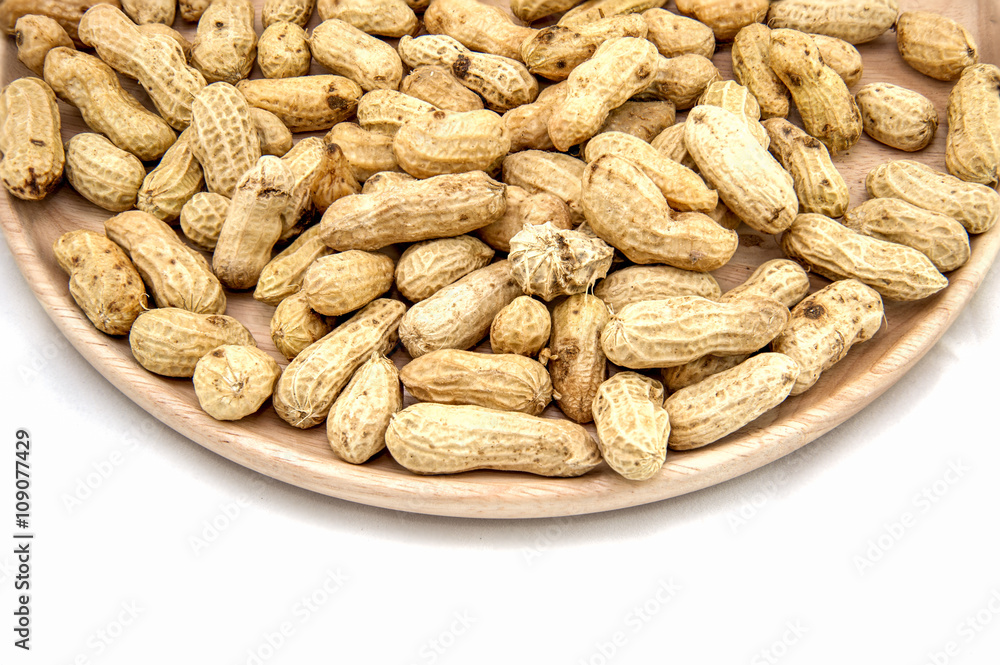 Wooden dish of nuts on white wooden background Wooden dish of nuts on white wooden background