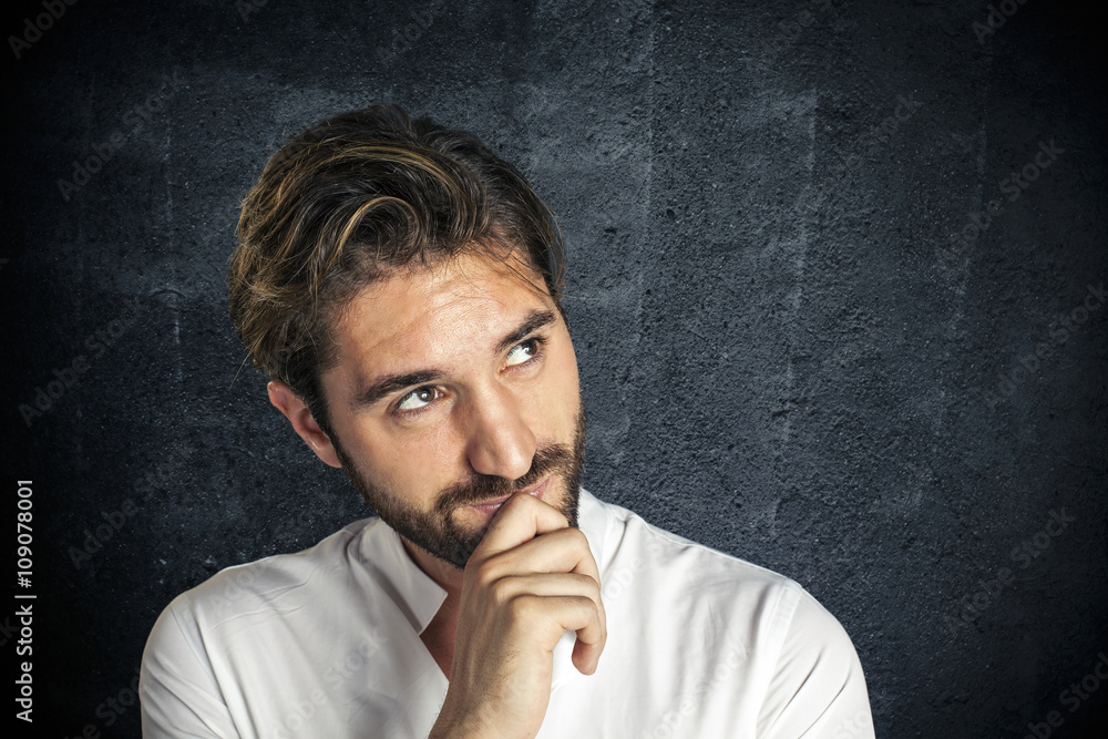 Pensive young man looks at copy space Pensive young man looks at copy space