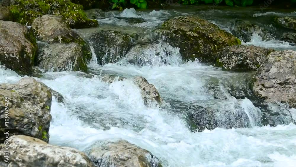 rapid stream with rocks and moss rapid stream with rocks and moss