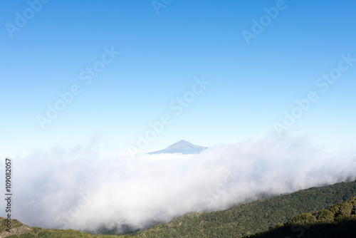Pico de Teide, the highest mountain in Spain on the Island Tenerife. Huge clouds from trade winds over the national park Garajonay on La Gomera. The clouds comes from the Azores in circa 800m altitude