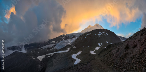 Panorama of snowy peak Elbrus in sunset