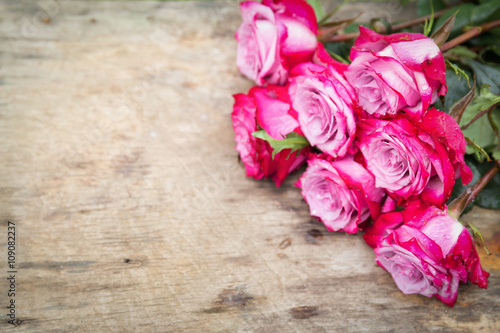 Fototapeta Naklejka Na Ścianę i Meble -  Perfect pink rose flower on wooden background outdoors