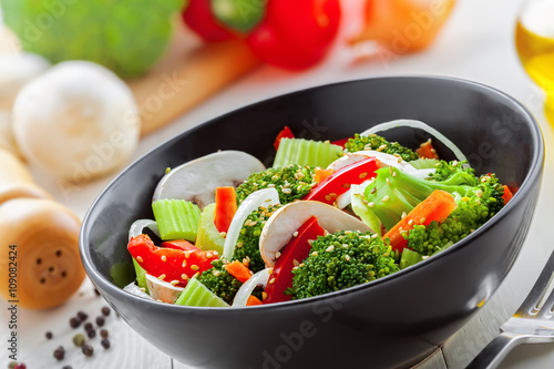 Healthy food made of broccoli, onion, mushroom, carrot and pepper. Vegetarian salad. Close-up.