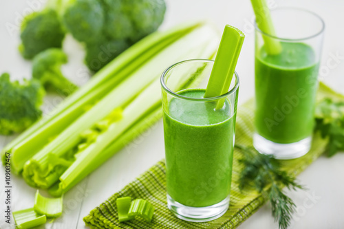 Glass of green smoothie on table, healthy vegetable drink