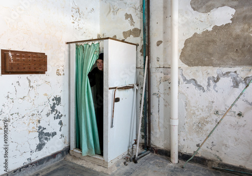 Abandoned shower and man inside Trans-Allegheny Lunatic Asylum