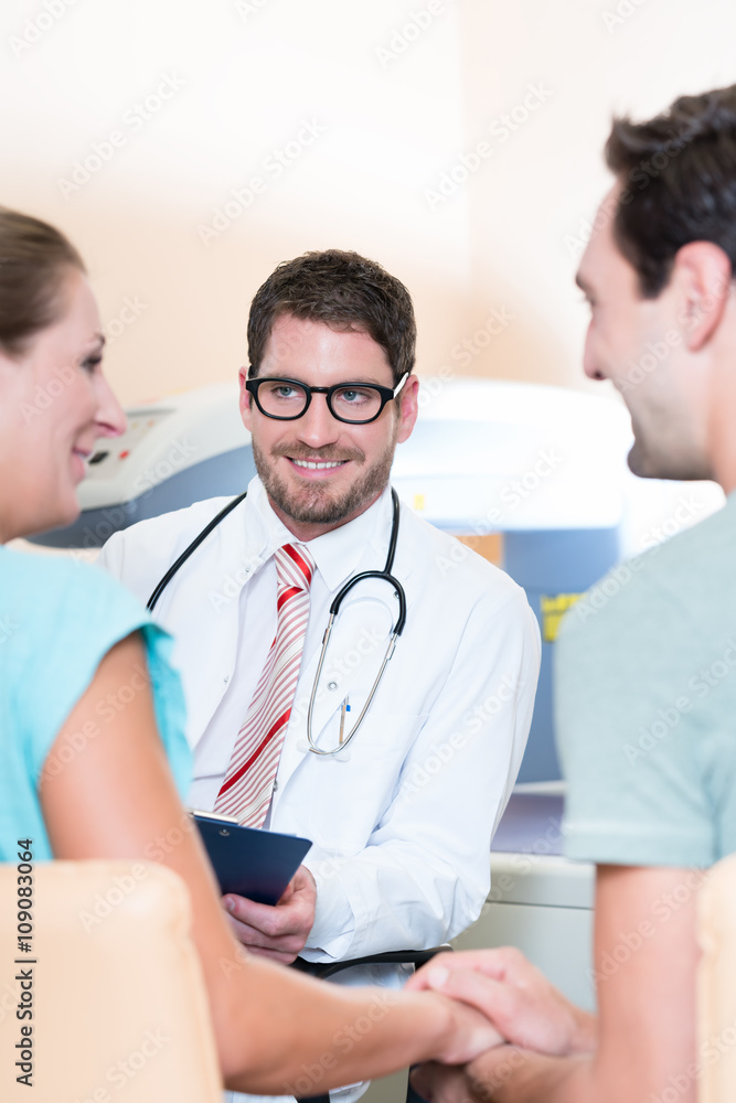 Fototapeta premium Pregnant woman and her partner seeing physician