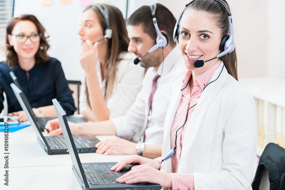 Woman and men working as call center agents Woman and men working as call center agents
