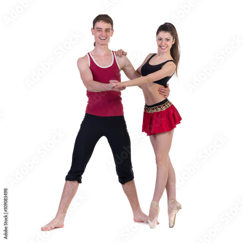 Full length of young ballet couple dancing on white background