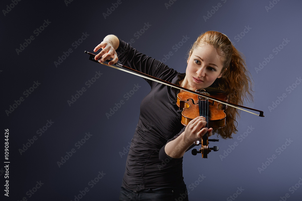 Beautiful young woman playing violin. Portrait of musician Beautiful young woman playing violin. Portrait of musician