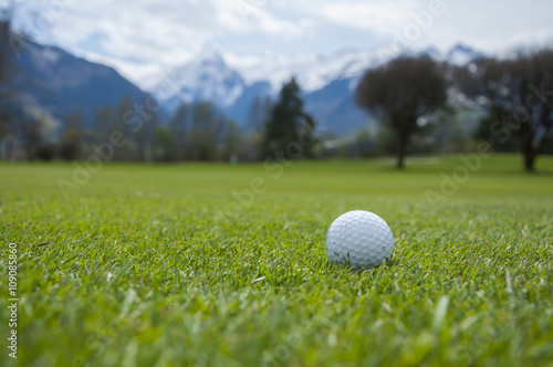 detail of golf ball on grass