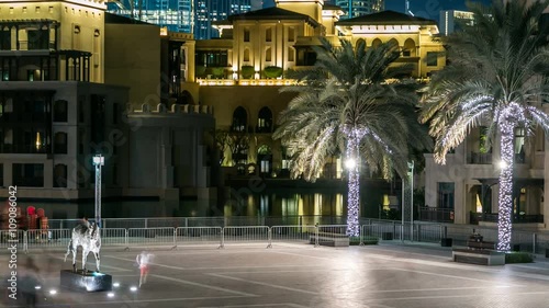 Square with horse monument near Souk and Burj Khalifa timelapse in Dubai, UAE photo