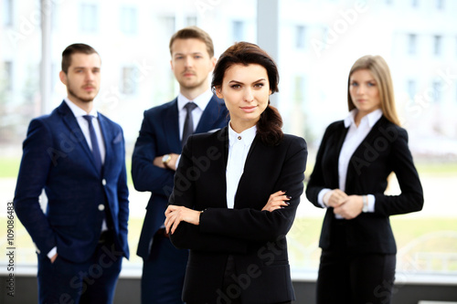 Face of beautiful woman on background of business people