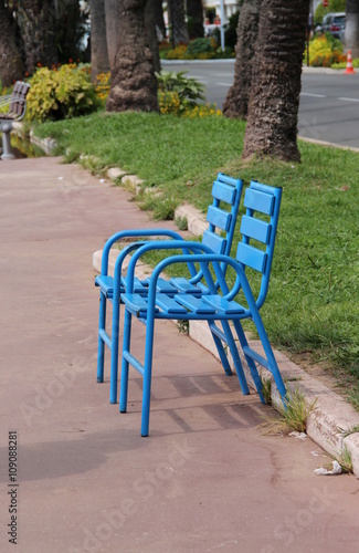 Blue chairs of Cannes and the city, French Riviera, France © Tanouchka