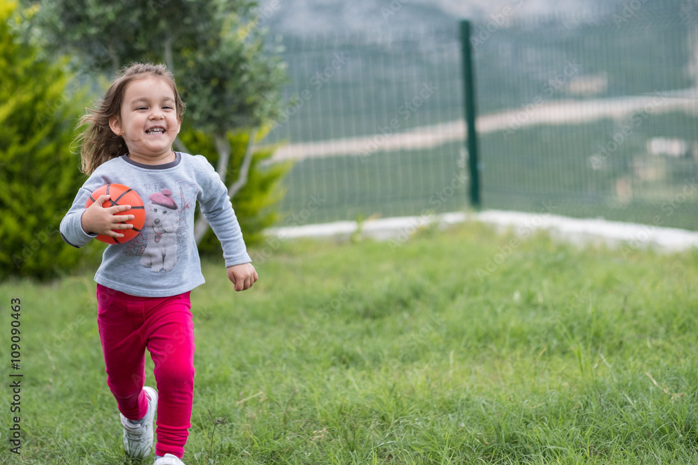 runnign child in garden with ball runnign child in garden with ball