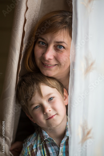 Closeup portrait of a mother with a young son.