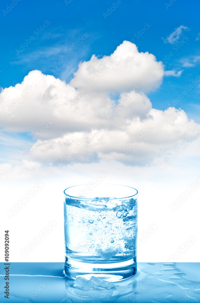 Sparkling water glass on blue sky Fresh cold drink Sparkling water glass on blue sky Fresh cold drink