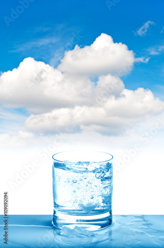 Sparkling water glass on blue sky Fresh cold drink
