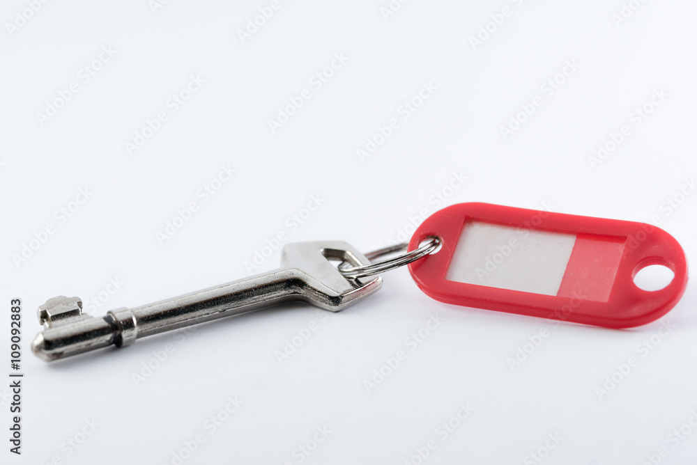 A Key and key fob without a label. A Key and key fob without a label.