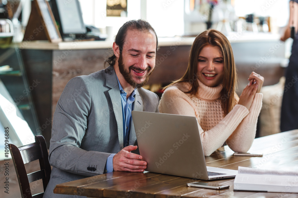 couple in a cafe looking to laptop couple in a cafe looking to laptop