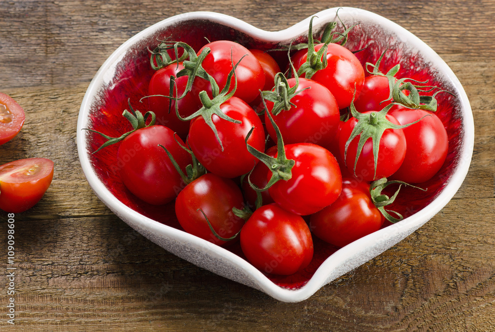 Fresh tomatoes in heart shaped plate. Fresh tomatoes in heart shaped plate.
