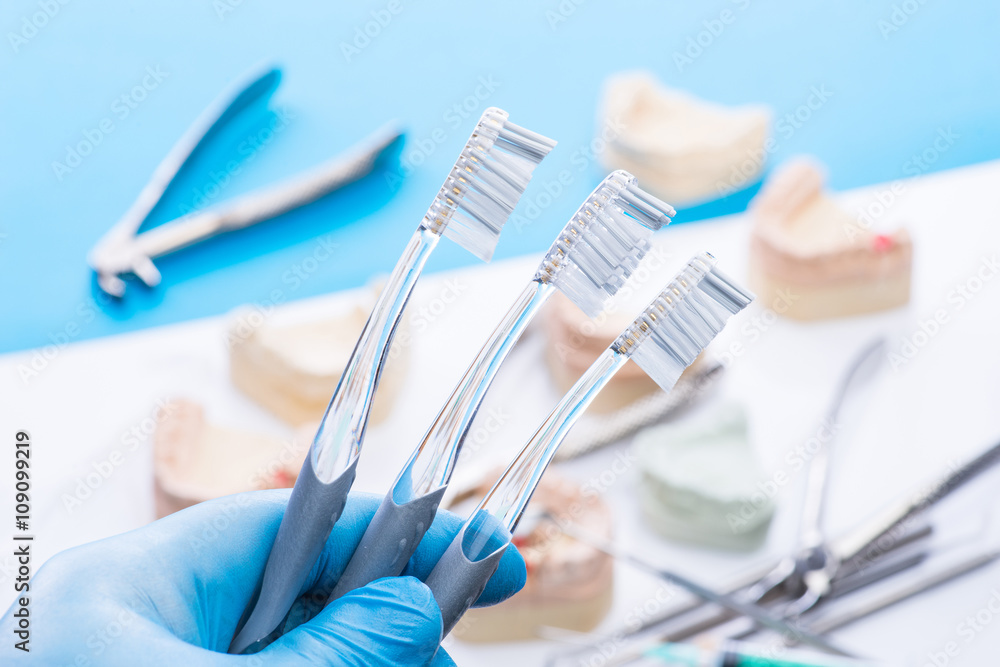 Teeth mold and basic dental tools on white table Teeth mold and basic dental tools on white table