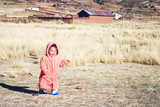 Little girl in orange bathrobe in the countryside