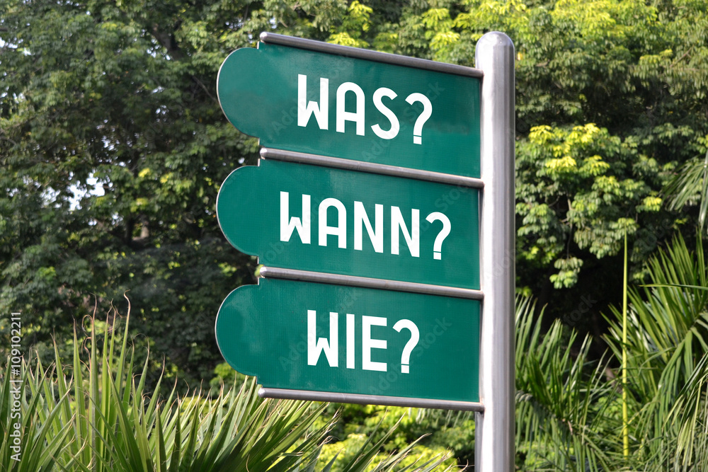 Was? Wann? Wie? Signpost in German.