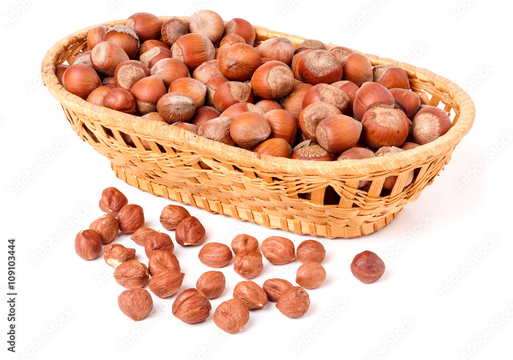 hazelnuts in a wicker basket isolated on white background hazelnuts in a wicker basket isolated on white background