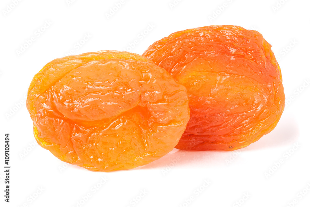 two dried apricots on a white background closeup two dried apricots on a white background closeup