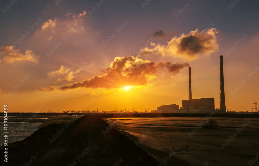  huge chimneys at sunrise. pollution.