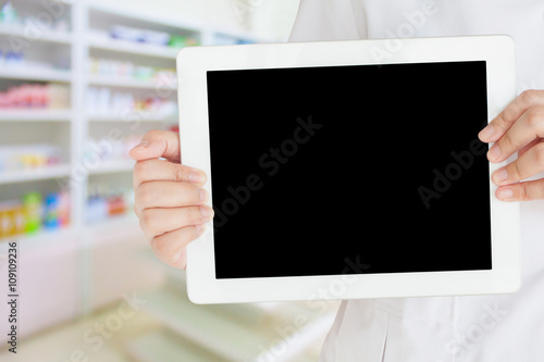 pharmacist showing tablet computer in the pharmacy