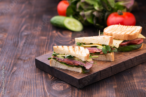 Sandwiches with bacon, cheese, greens and pea sprouts photo