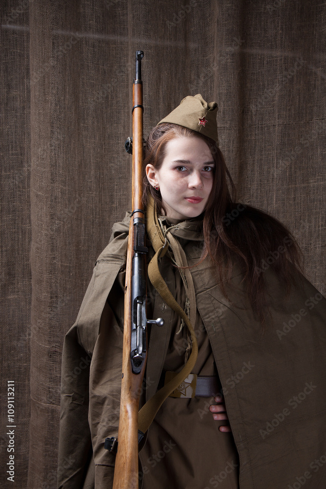 Fototapeta premium Woman in Russian military uniform with rifle. Female soldier during the second world war.