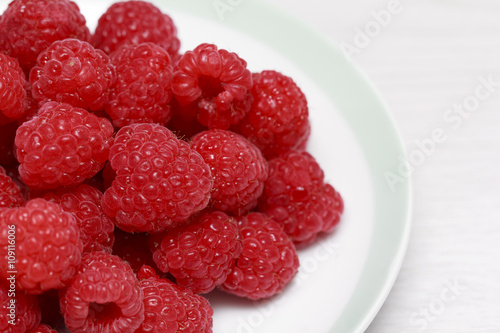 Fresh raspberries in white dish