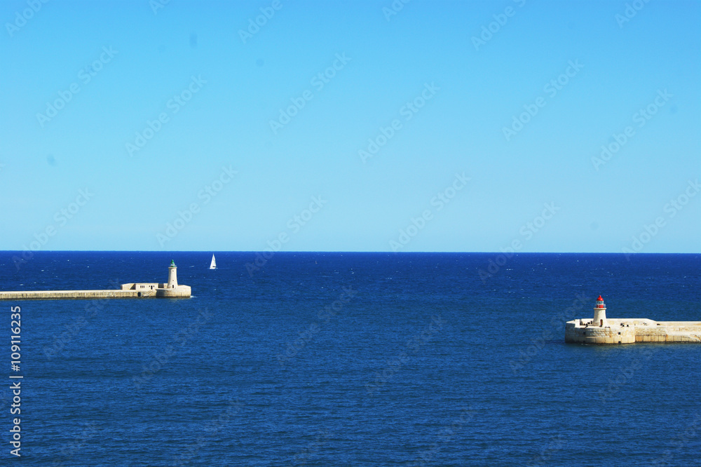 Two white lighthouse on the coast of Malta in the Mediterranean Sea