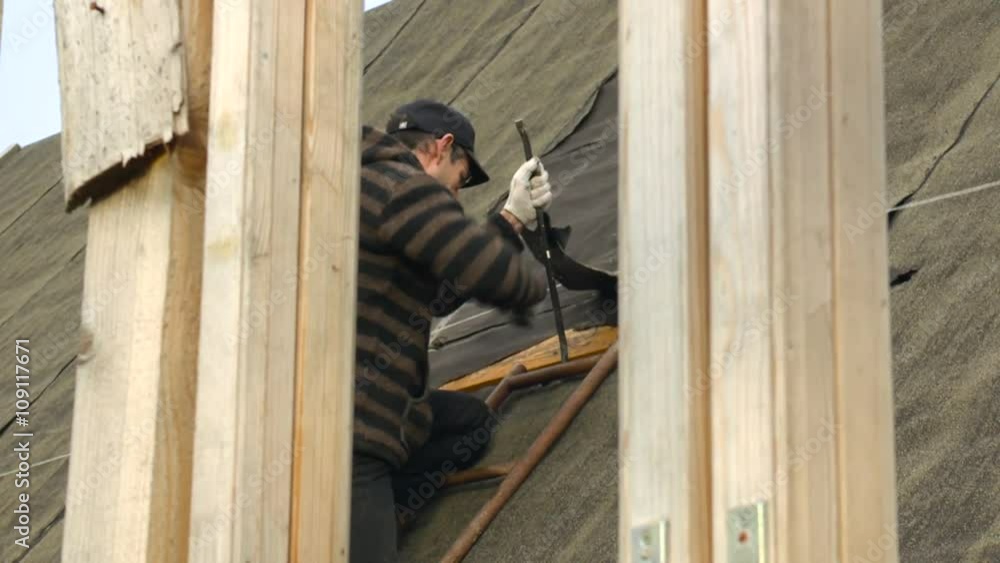 Man Midle Age in the Eyeglasses in the Country Repairing a Roof Day Autumn, Russia Man Midle Age in the Eyeglasses in the Country Repairing a Roof Day Autumn, Russia